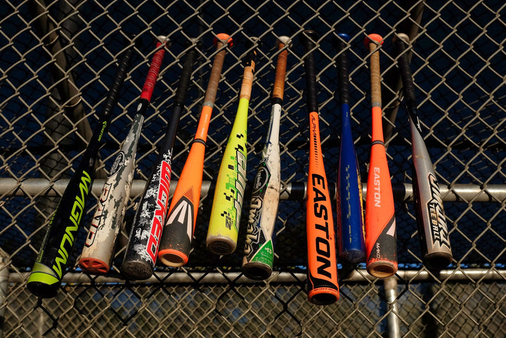 Baseball Bats on chain link fence